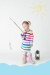 Girl playing fishing with toy fish