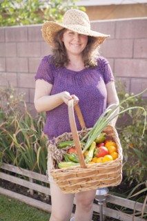 Mixed race gardener gathering vegetables in garden