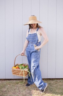Mixed race farmer holding basket of vegetables