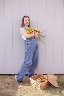 Mixed race farmer with basket of vegetables