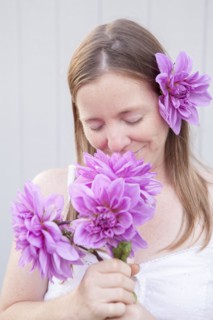Mixed race woman smelling flowers