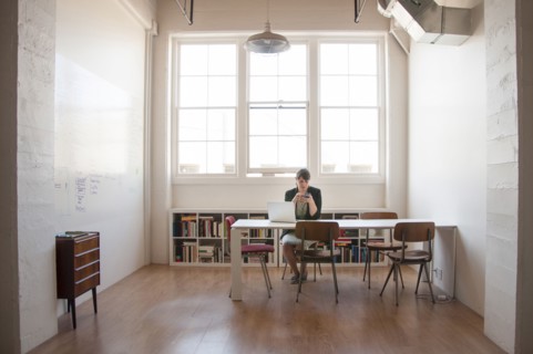 Caucasian businesswoman working on laptop in office