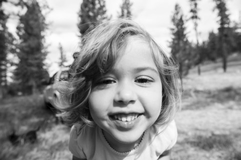Close up of smiling Caucasian girl on hillside