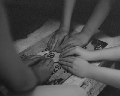 High angle view of children playing with ouija board