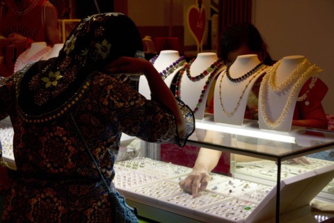 Woman shopping for jewelry in store