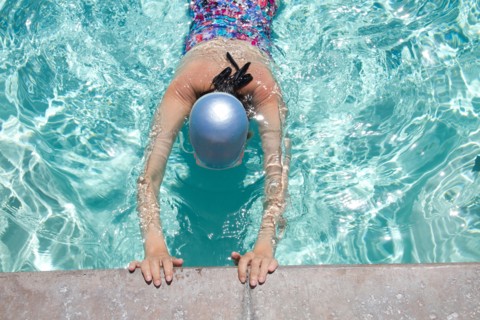 High angle view of Caucasian woman swimming in pool