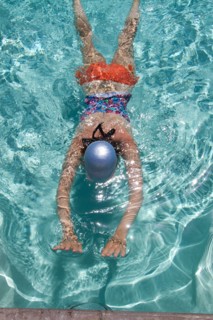 High angle view of Caucasian woman swimming in pool