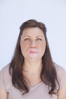 Caucasian woman blowing bubble with gum