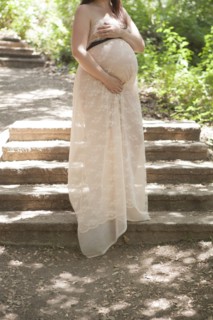 Pregnant Caucasian woman standing on hillside steps