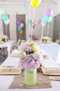 Place settings on party tables under balloons