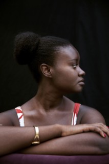 Black woman leaning on forearms