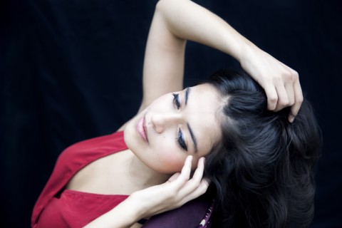 Mixed race woman leaning on armchair