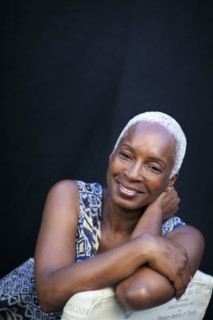 Smiling woman leaning on chair back