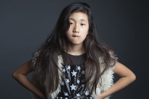 Asian girl standing with hands on hips