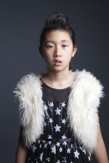 Serious Asian girl wearing furry vest