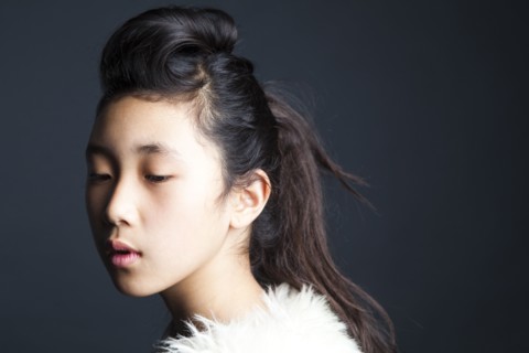 Serious Asian girl wearing fur shawl