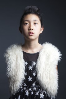 Serious Asian girl wearing furry vest