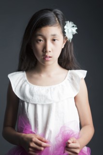 Serious Asian girl wearing flower in her hair