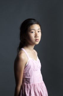 Serious Asian girl wearing dress