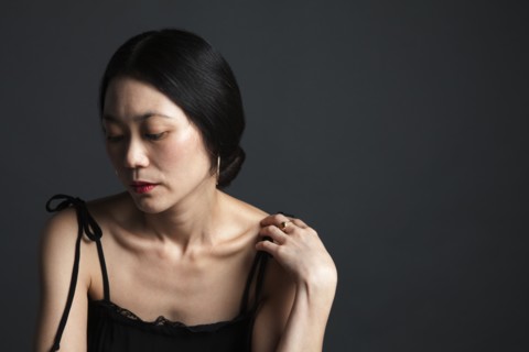 Disappointed Asian woman looking down