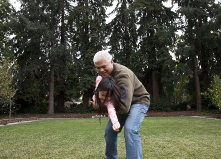Father and daughter playing in backyard