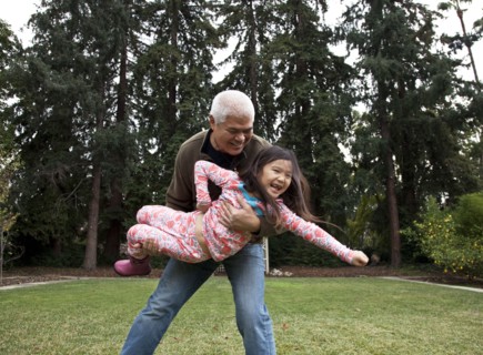 Father and daughter playing in backyard