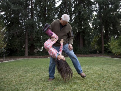 Father and daughter playing in backyard