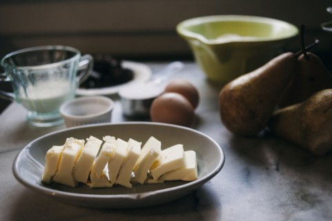 Close up of baking ingredients and pears on marble counter