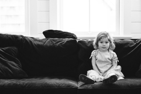 Smiling girl sitting on sofa