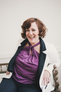 Woman laughing on wooden bench