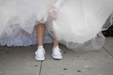Teenage girl wearing sneakers under quinceanera dress