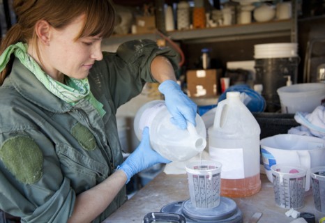 Entrepreneur pouring liquid in workshop