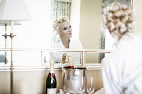 Caucasian woman admiring her hair in mirror