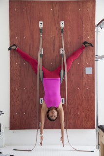 Asian woman using exercise equipment in gymnasium