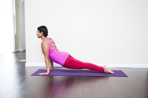 Asian woman practicing yoga in studio