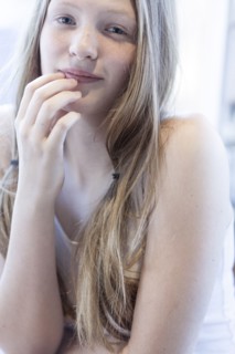 Smiling girl resting chin in hand