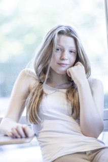Smiling girl leaning on table
