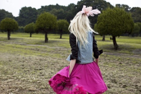 Stylish woman walking in rural field