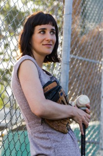 Baseball player leaning on fence