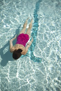 High angle view of Caucasian woman swimming in pool