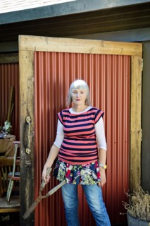 Older Caucasian woman holding shears in backyard