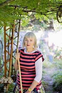 Older Caucasian woman gardening in backyard