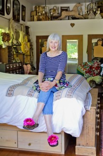 Older Caucasian woman sitting on bed