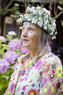 Stylish older Caucasian woman wearing floral cap