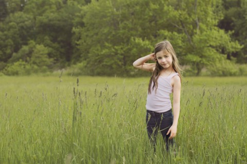 Caucasian girl standing in rural field