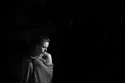 Caucasian woman wrapped in blanket