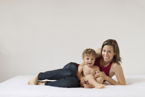 Caucasian mother and son laying on bed