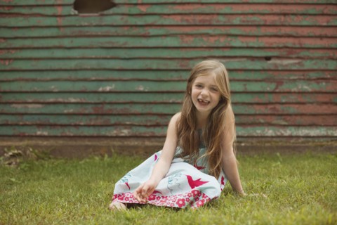 Caucasian girl sitting in backyard