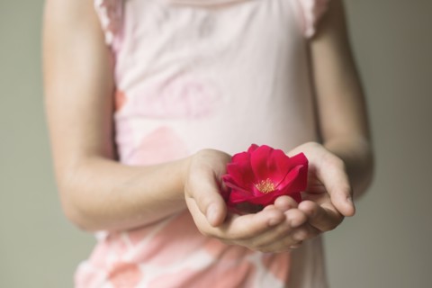 Caucasian girl holding blooming flower