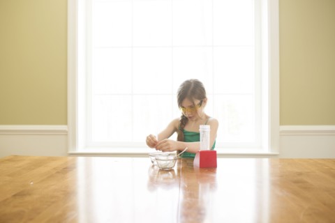 Caucasian girl cooking at table